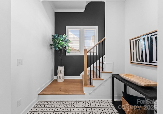 staircase with baseboards and ornamental molding