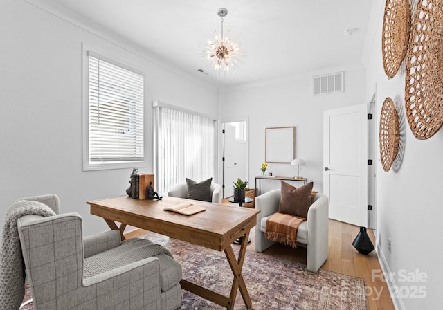 home office featuring visible vents, ornamental molding, wood finished floors, a chandelier, and baseboards