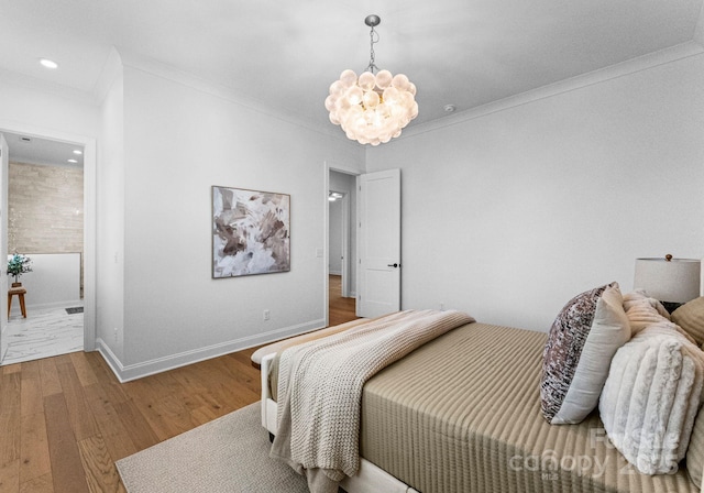 bedroom featuring crown molding, recessed lighting, an inviting chandelier, wood finished floors, and baseboards