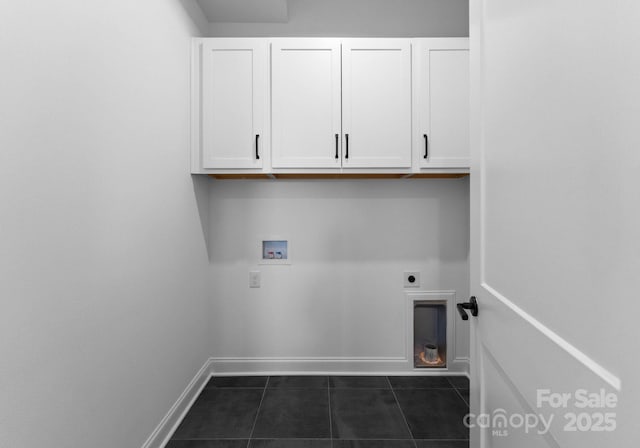 washroom featuring hookup for a washing machine, cabinet space, electric dryer hookup, dark tile patterned floors, and baseboards