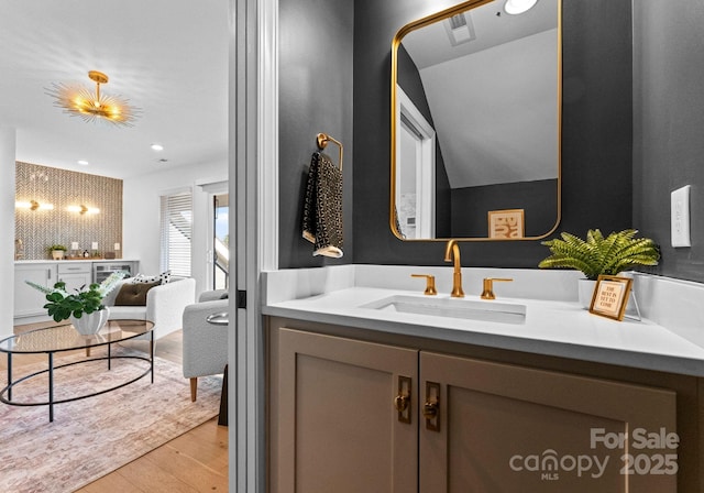 bathroom featuring visible vents, vanity, and wood finished floors