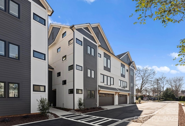 view of property with a garage and a residential view