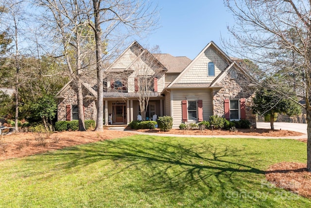 craftsman-style house with a front yard and stone siding