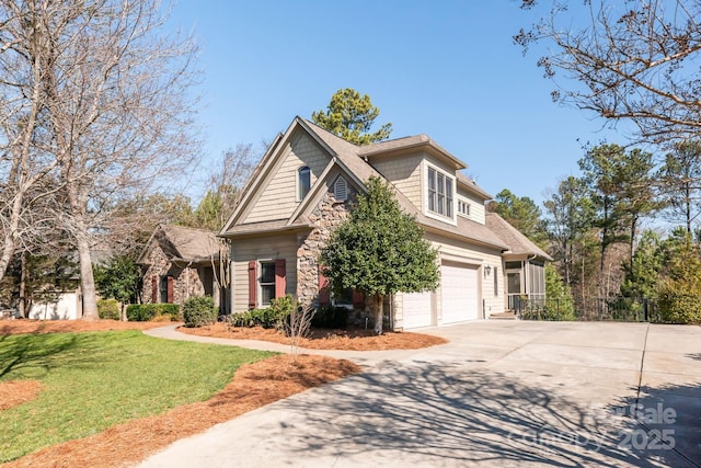 view of front of house featuring a garage, stone siding, driveway, and a front lawn