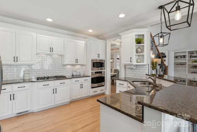 kitchen featuring a sink, visible vents, white cabinets, appliances with stainless steel finishes, and open shelves