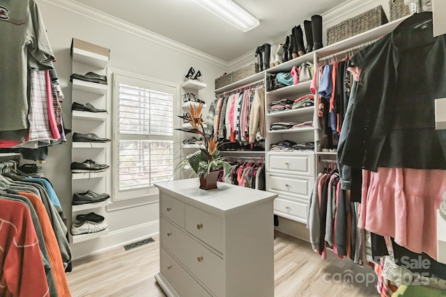 spacious closet with light wood-type flooring and visible vents