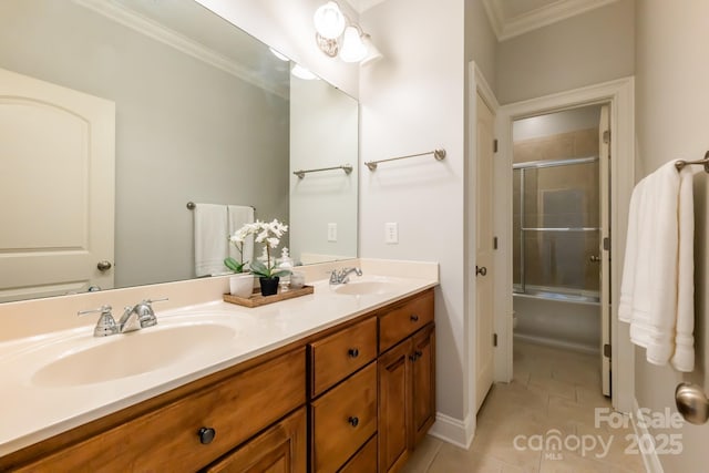 bathroom with crown molding, tile patterned floors, a sink, and double vanity