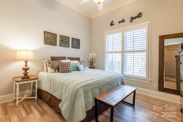 bedroom featuring crown molding, baseboards, and wood finished floors