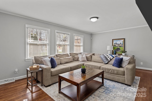 living area featuring ornamental molding, wood finished floors, visible vents, and baseboards