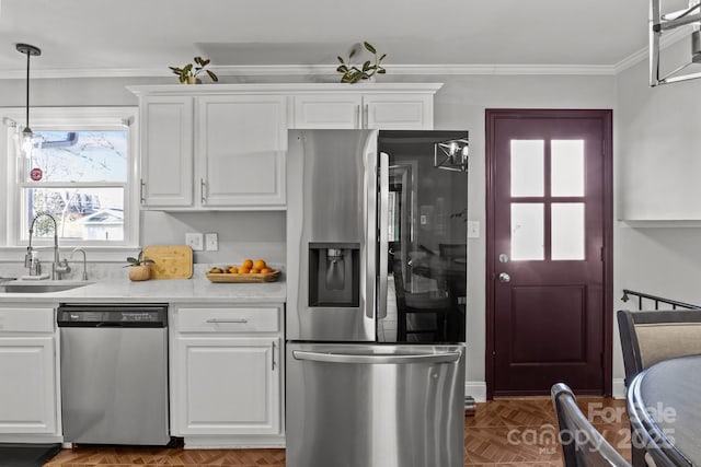 kitchen with ornamental molding, a sink, stainless steel appliances, white cabinets, and light countertops