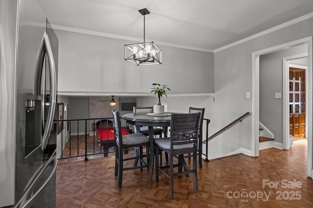 dining room featuring ceiling fan with notable chandelier, stairs, crown molding, and baseboards