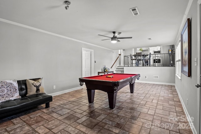 rec room with visible vents, stone finish flooring, crown molding, and baseboards