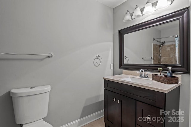 full bathroom with baseboards, toilet, and vanity