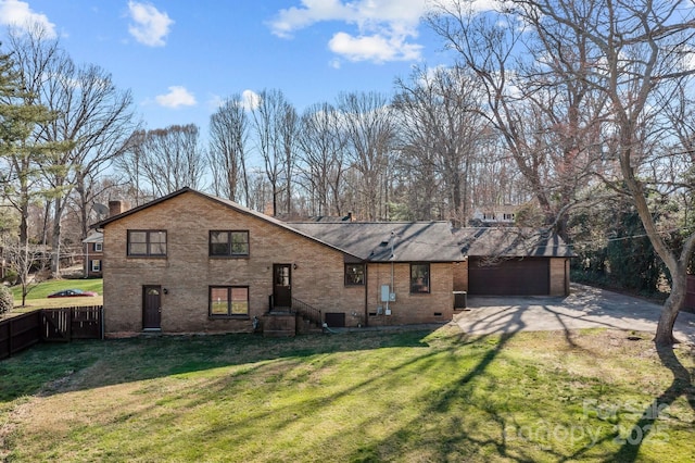 view of front of property featuring driveway, fence, a front yard, a garage, and a chimney