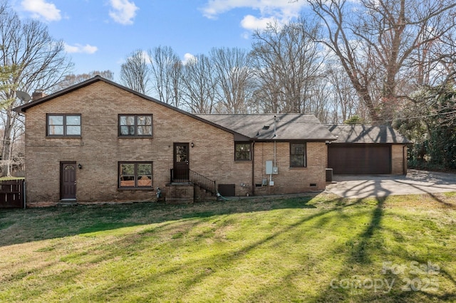 view of front of home with a front yard, a garage, brick siding, and driveway