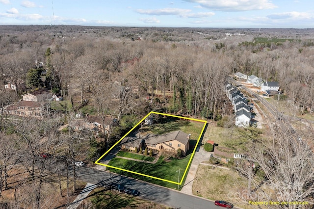 birds eye view of property featuring a forest view