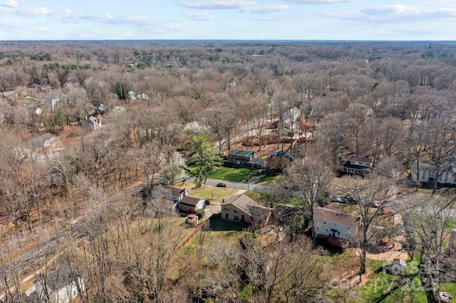 birds eye view of property featuring a view of trees