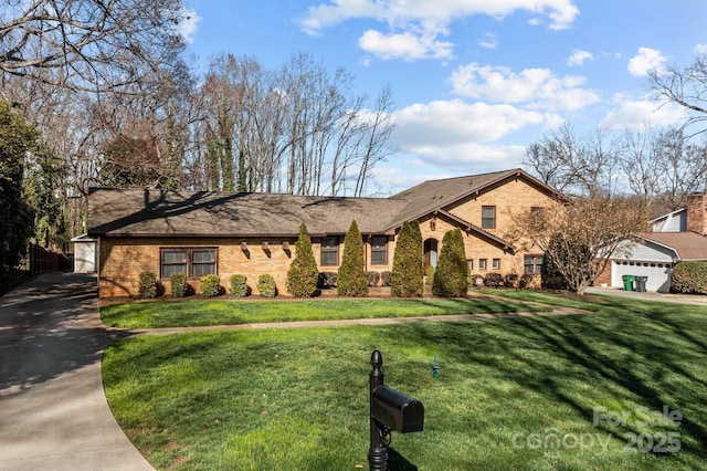 view of front facade with brick siding, driveway, and a front lawn