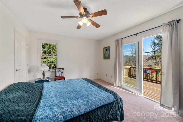 bedroom with ceiling fan, multiple windows, carpet, and access to exterior