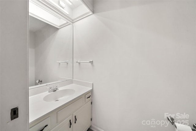 bathroom with a skylight and vanity