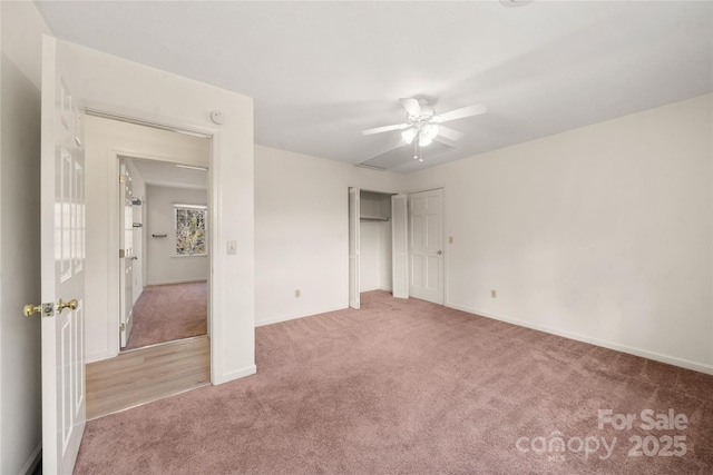 unfurnished bedroom featuring ceiling fan, a closet, carpet, and baseboards