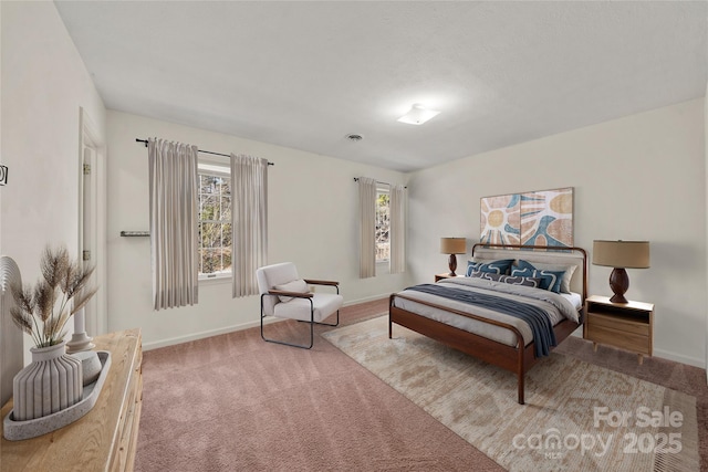 carpeted bedroom with baseboards