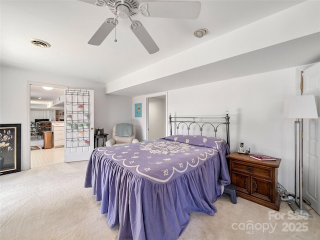 bedroom with carpet floors, ceiling fan, and visible vents