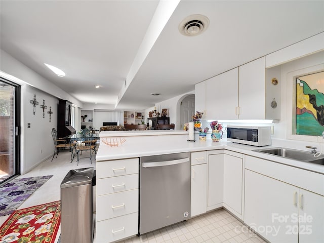 kitchen featuring white cabinetry, light countertops, dishwasher, and white microwave