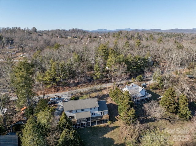 aerial view featuring a mountain view and a wooded view