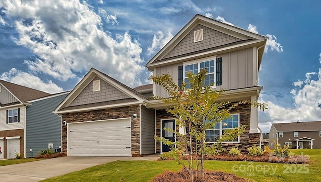 craftsman house featuring concrete driveway, an attached garage, board and batten siding, stone siding, and a front lawn