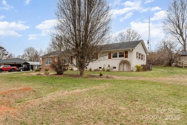 ranch-style house featuring a carport and a front yard