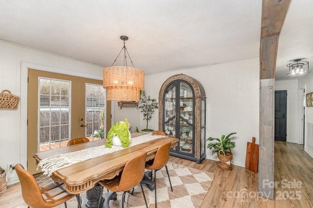 dining area with light wood-type flooring and french doors