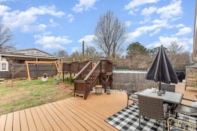 deck featuring outdoor dining space and fence