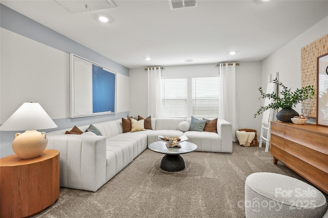 carpeted living room with attic access, recessed lighting, and visible vents