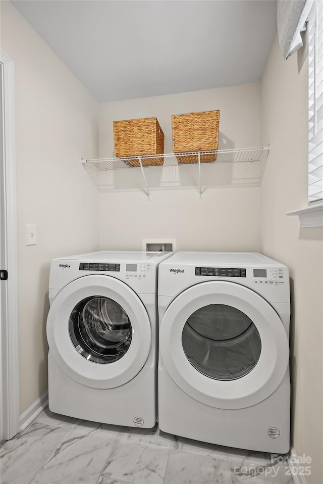 washroom featuring marble finish floor, laundry area, independent washer and dryer, and baseboards