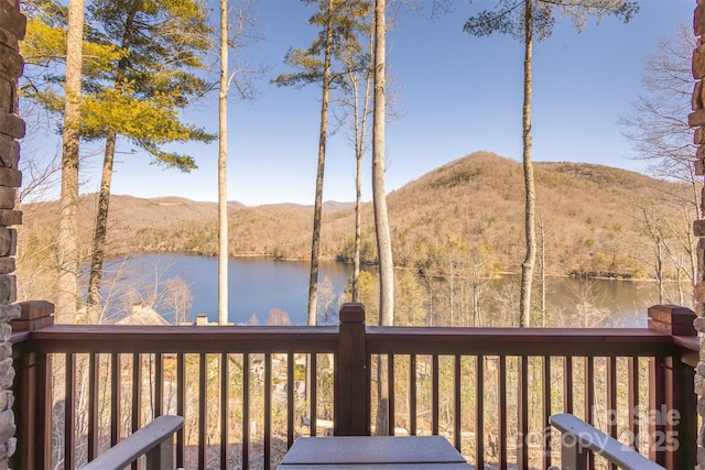 wooden deck featuring a water and mountain view