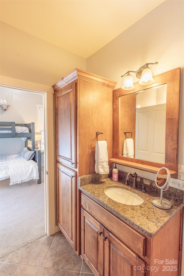 ensuite bathroom featuring ensuite bathroom, tile patterned flooring, and vanity