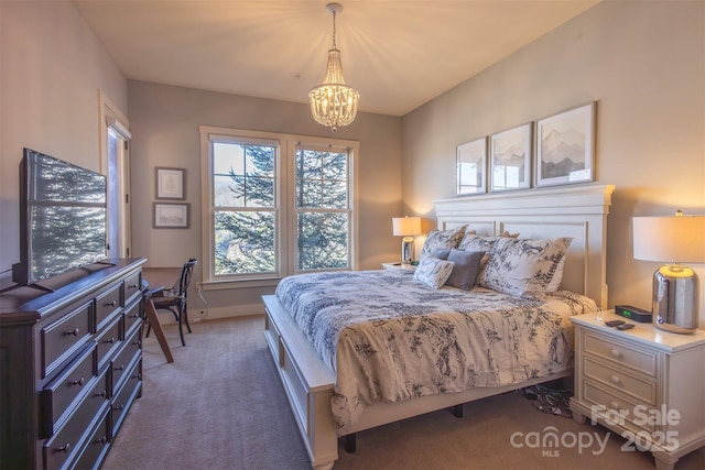 bedroom featuring baseboards, carpet, and an inviting chandelier