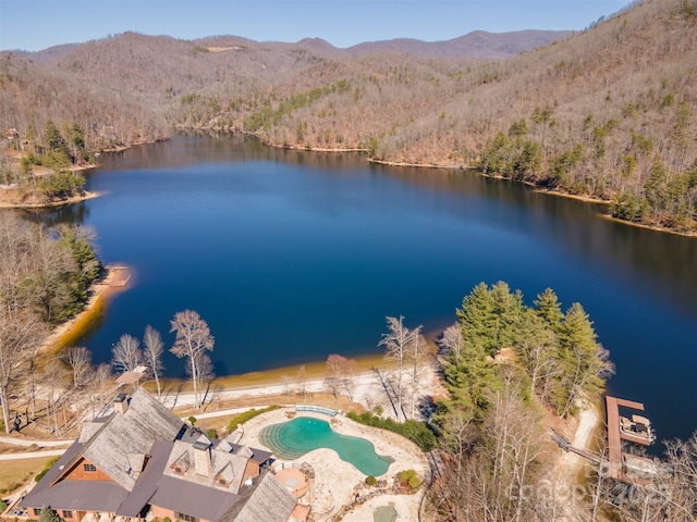 birds eye view of property with a wooded view and a water and mountain view