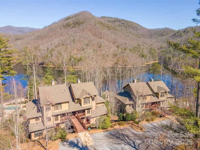 aerial view featuring a view of trees and a water and mountain view