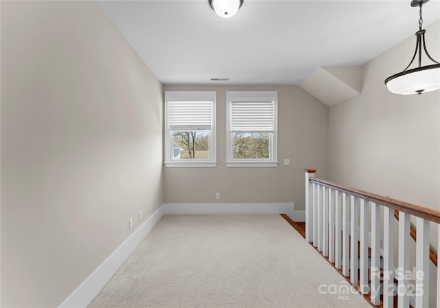 bonus room with baseboards and carpet floors