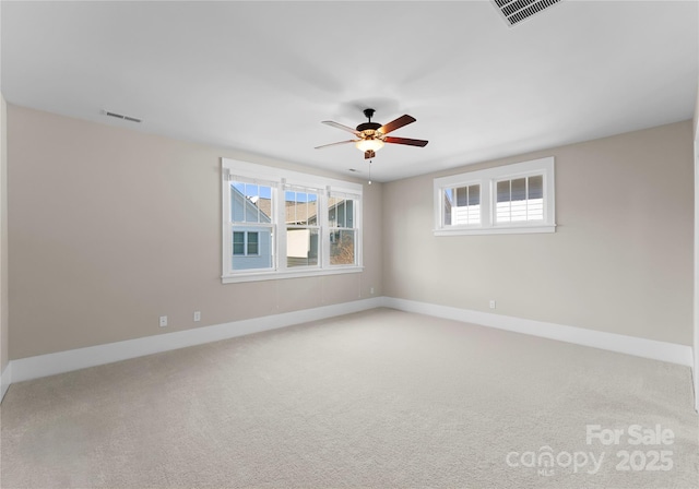 spare room with visible vents, baseboards, carpet, and a ceiling fan