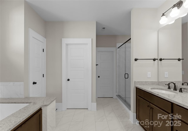 full bath featuring vanity, marble finish floor, and a shower stall