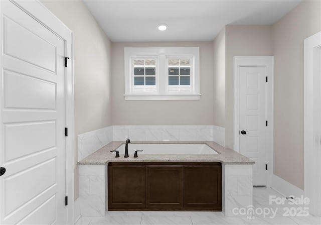 full bath featuring a garden tub and marble finish floor