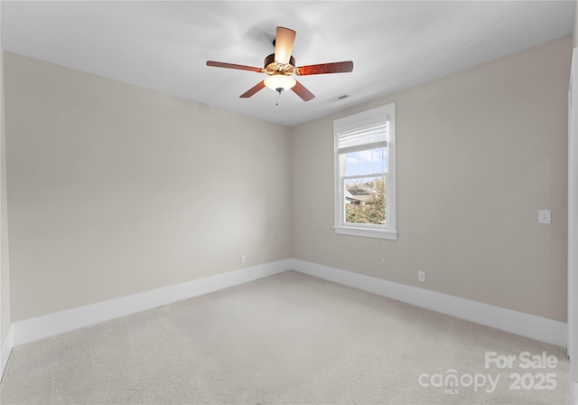 empty room featuring a ceiling fan, baseboards, visible vents, and carpet floors