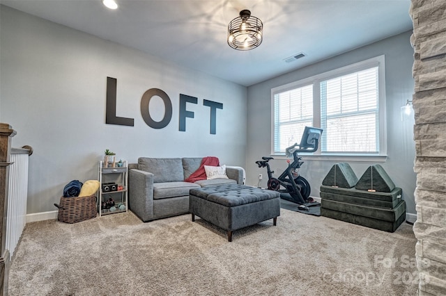 carpeted living area featuring visible vents and baseboards