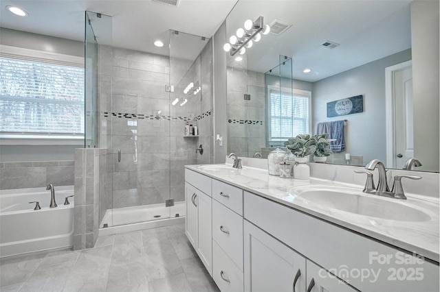 bathroom featuring double vanity, a sink, visible vents, and a shower stall