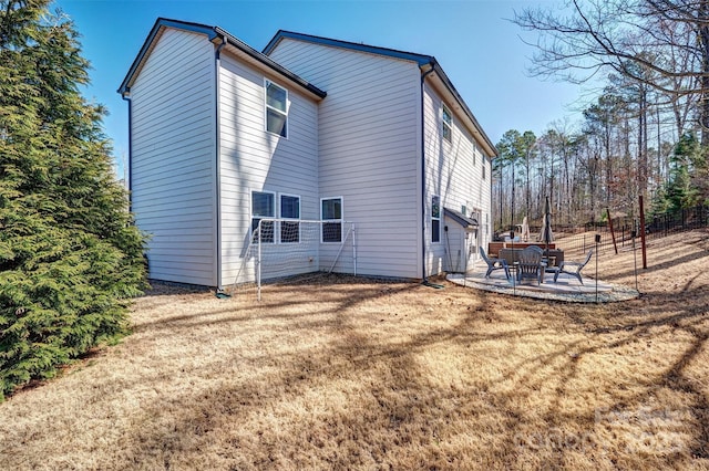 back of house with a yard, a patio area, and fence