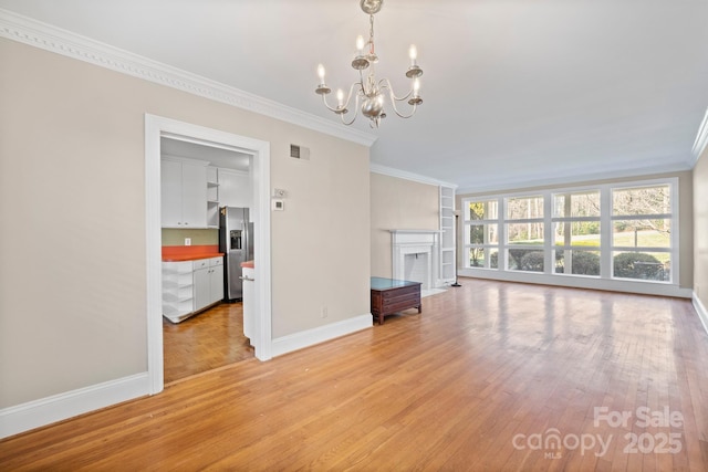 unfurnished living room featuring crown molding, visible vents, a fireplace with flush hearth, light wood-type flooring, and baseboards