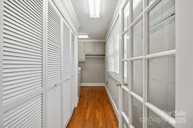 hall featuring baseboards and wood finished floors